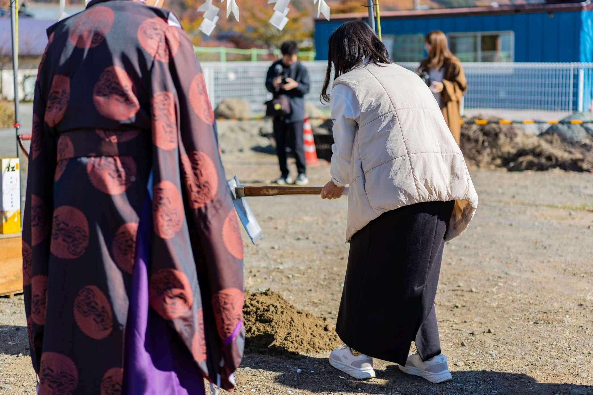 山梨県富士吉田市大明見の建築現場。地鎮祭にて奥様が鍬入れをしている様子。