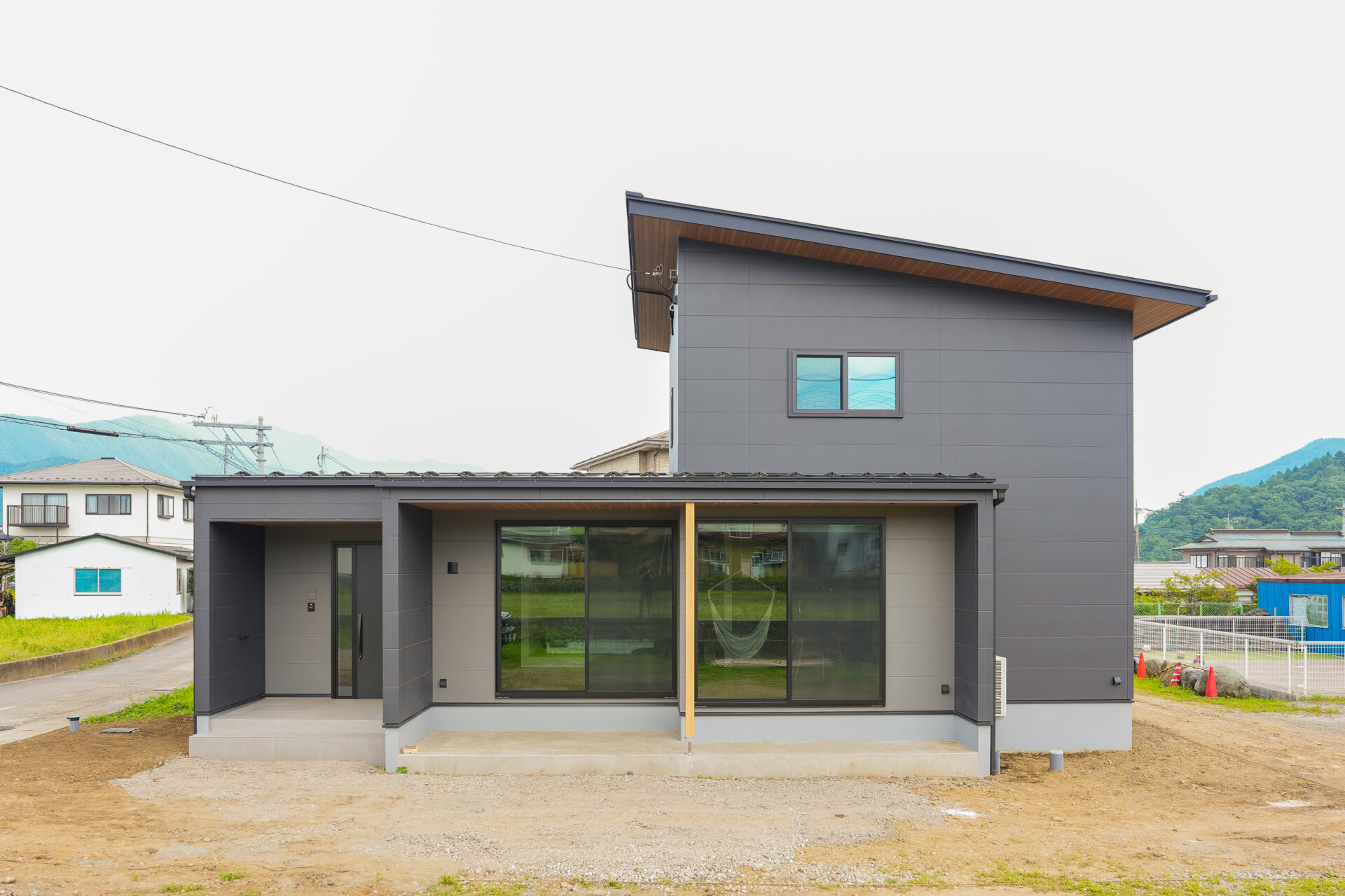 山梨県富士吉田市大明見の新築現場の外観。濃いグレーを基調としたモダンな外観。